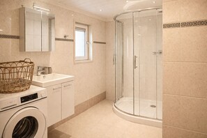 Shower, hair dryer, soap, toilet paper