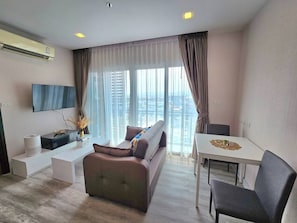 Signature Condo | Living area | 43-inch Smart TV with digital channels, TV, Netflix - The Prio Condo (Chiang Mai)