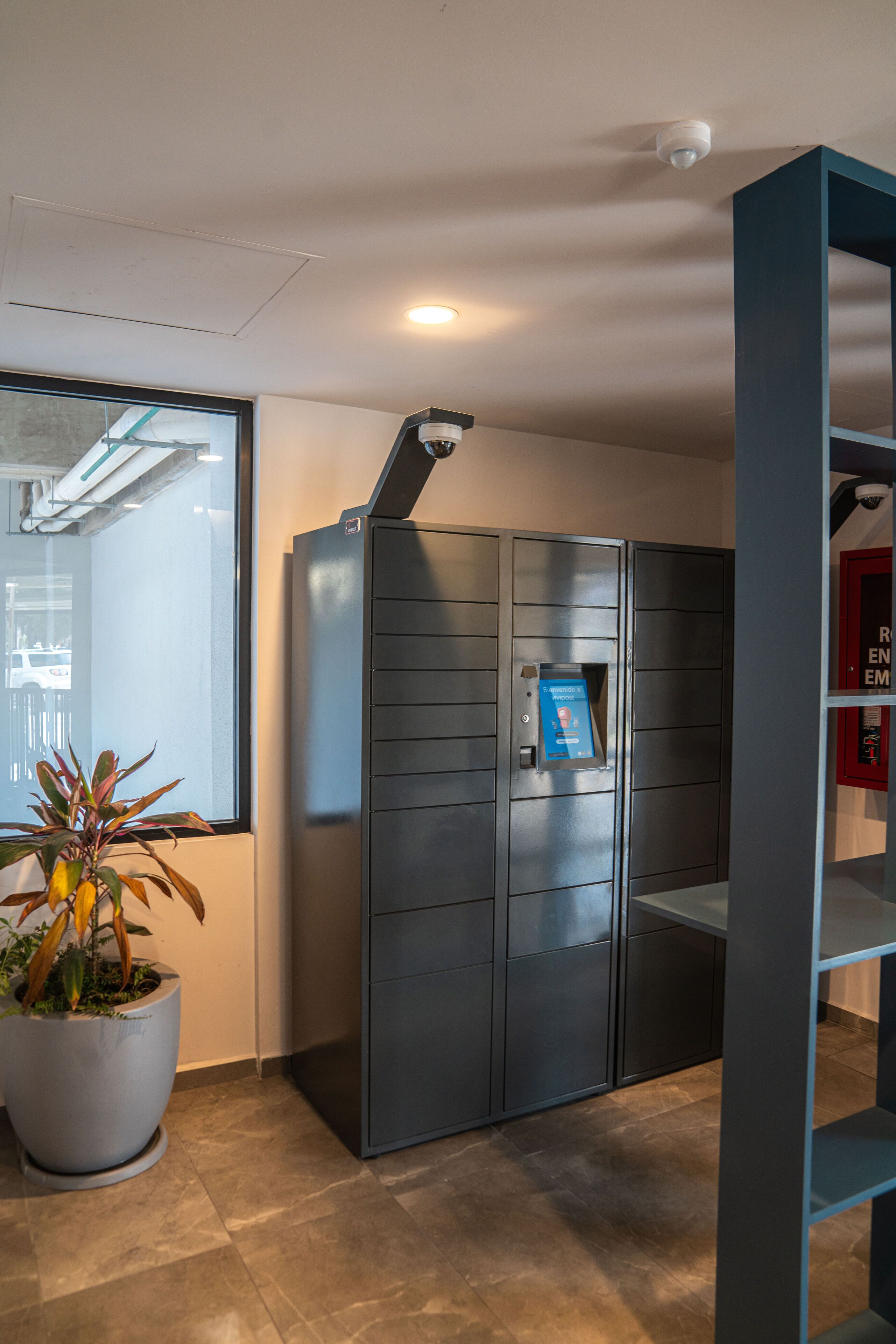 A modern elevator with a digital display and emergency instructions.