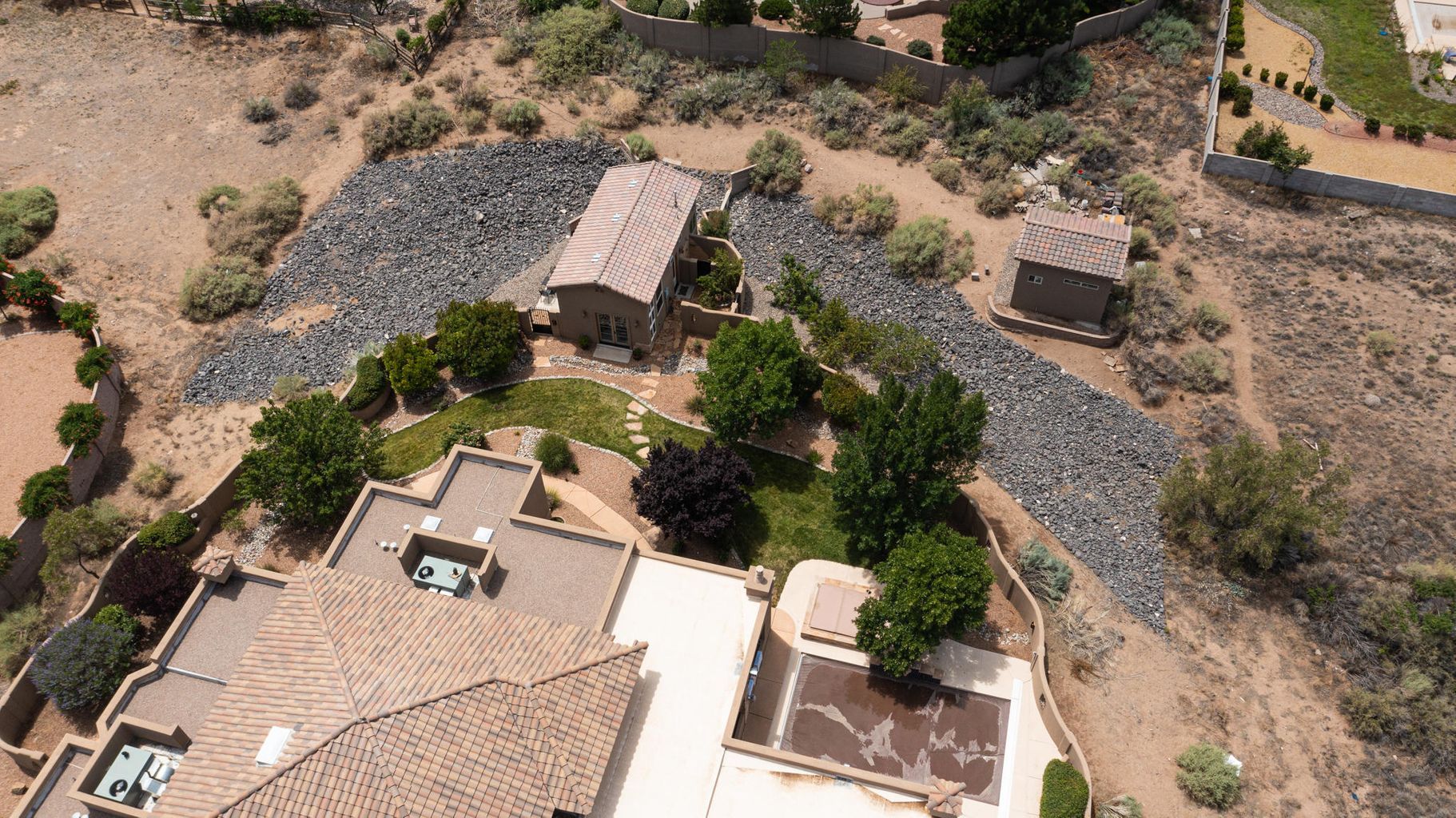 Zona residencial amb diverses cases, un carrer pavimentat i jardins ben cuidats.