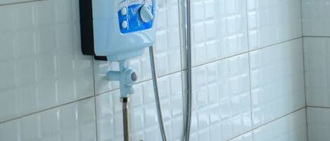 A wall-mounted shower unit with a control panel and a handheld showerhead.