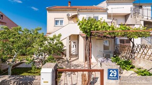 A residential building with a white facade, a red-tiled roof, and a visible number '29'. - Studio Apartment Jagoda (Šibenik-Brodarica)