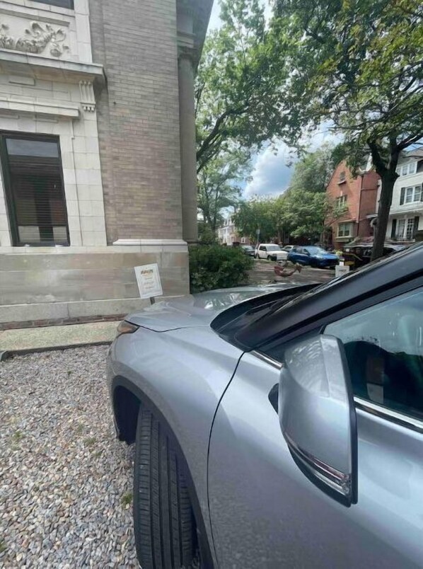 A silver car parked in front of a building with a stone facade and a window with a closed shutter. - Historic private guest apartment (Norfolk)