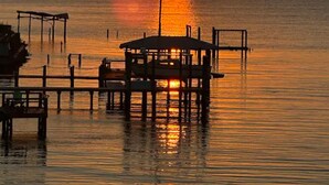 A pier extending into calm waters at sunset with a clear sky. - Waterfront! Private, Sunrises & Sunsets, Sea life, Deck, 10 minutes to Destin! (Niceville)