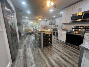 Enjoy cooking in this well-equipped kitchen with a central island, stove, and oven.