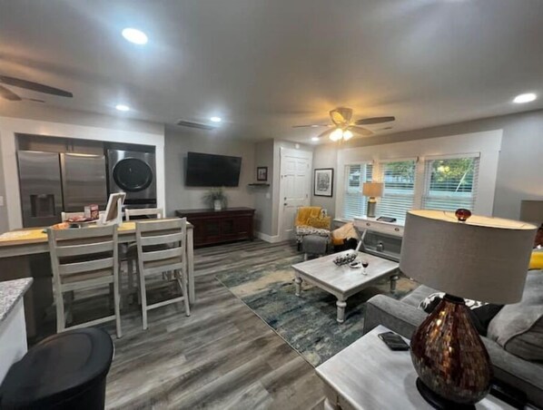 Relax in a spacious living area with a dining table, sofa, and armchairs.
