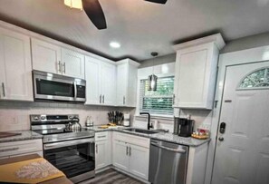 Enjoy cooking in this well-equipped kitchen with a microwave, oven, and dishwasher.