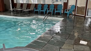 An indoor swimming pool with lounge chairs and a hot tub. - Trade Winds on the Bay (Rockland)