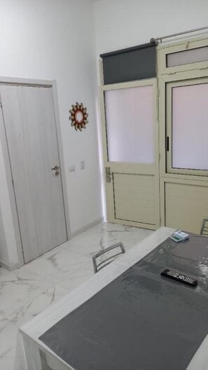 Simple, clean design with a large window and marble floor.