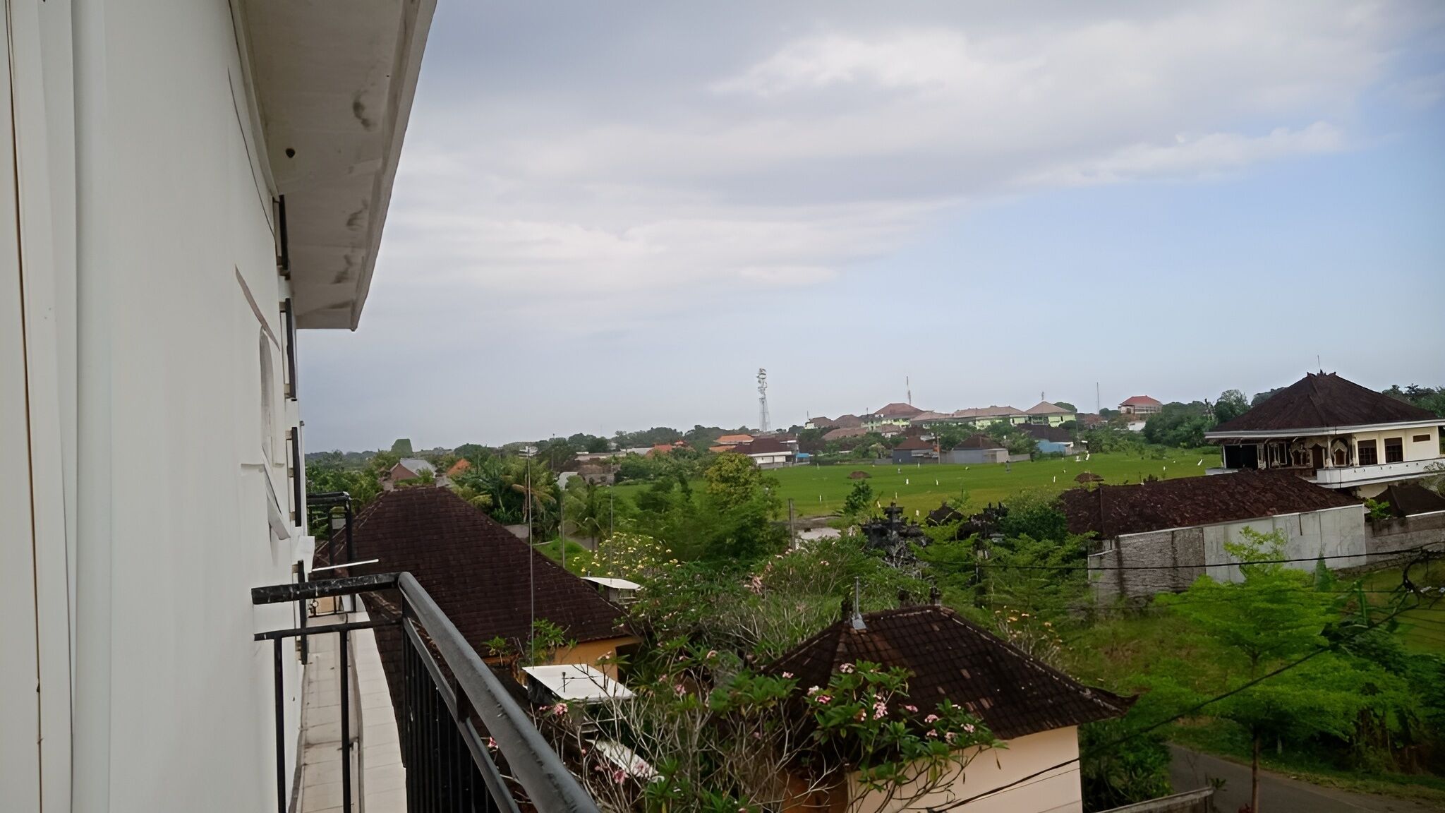 A residential area with houses, a clear sky, and a distant tower.