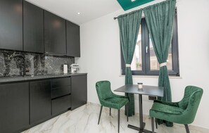 Enjoy meals at the dining table with a coffee machine nearby.
