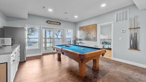 A pool room with a pool table, a sign reading "Symphony," and a painting on the wall. - 1528 - Sound and Color - Spacious Soundfront Retreat w/ Stunning Sunsets (Corolla)