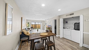 Relax in a spacious living area with a dining table, sofa, and kitchenette.