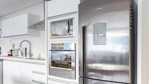 A modern kitchen with a stainless steel refrigerator, built-in oven, and a microwave. - Nice in Leblon View to Morro 2 irm os Guc6 ZN1 (Rio de Janeiro)