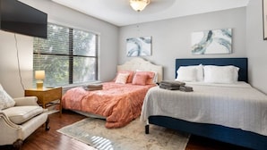 A bedroom with two beds, a TV, and artwork on the walls. - Lg 3 bedroom home with game rm (San Antonio)