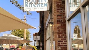 A storefront with a sign reading "BOUNTY KITCHEN" and "QUEEN ANNE - SEATTLE".