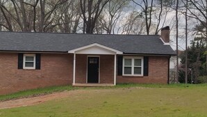 A single-story brick house with a gabled roof, a front porch, and a small front yard. - 3 Bedroom House Near Hickory  (Granite Falls)