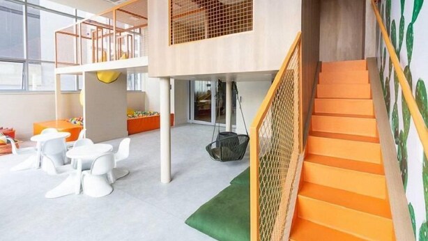 A multi-level play area with a staircase and netted play structures. - Helbor Wide (São Paulo)