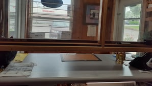 A reception desk with a view of a Walgreens store through a window. - Scenic River Inn Wartburg Hwy 27 (Wartburg)