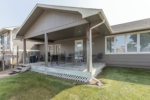 A covered patio with outdoor furniture, a grill, and a white fence. - Lazy Days M-01A - Three Bedroom House, Sleeps 10 (Osage Beach)