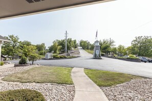 A residential street with houses, a central road, and a small tower-like structure with an American flag.