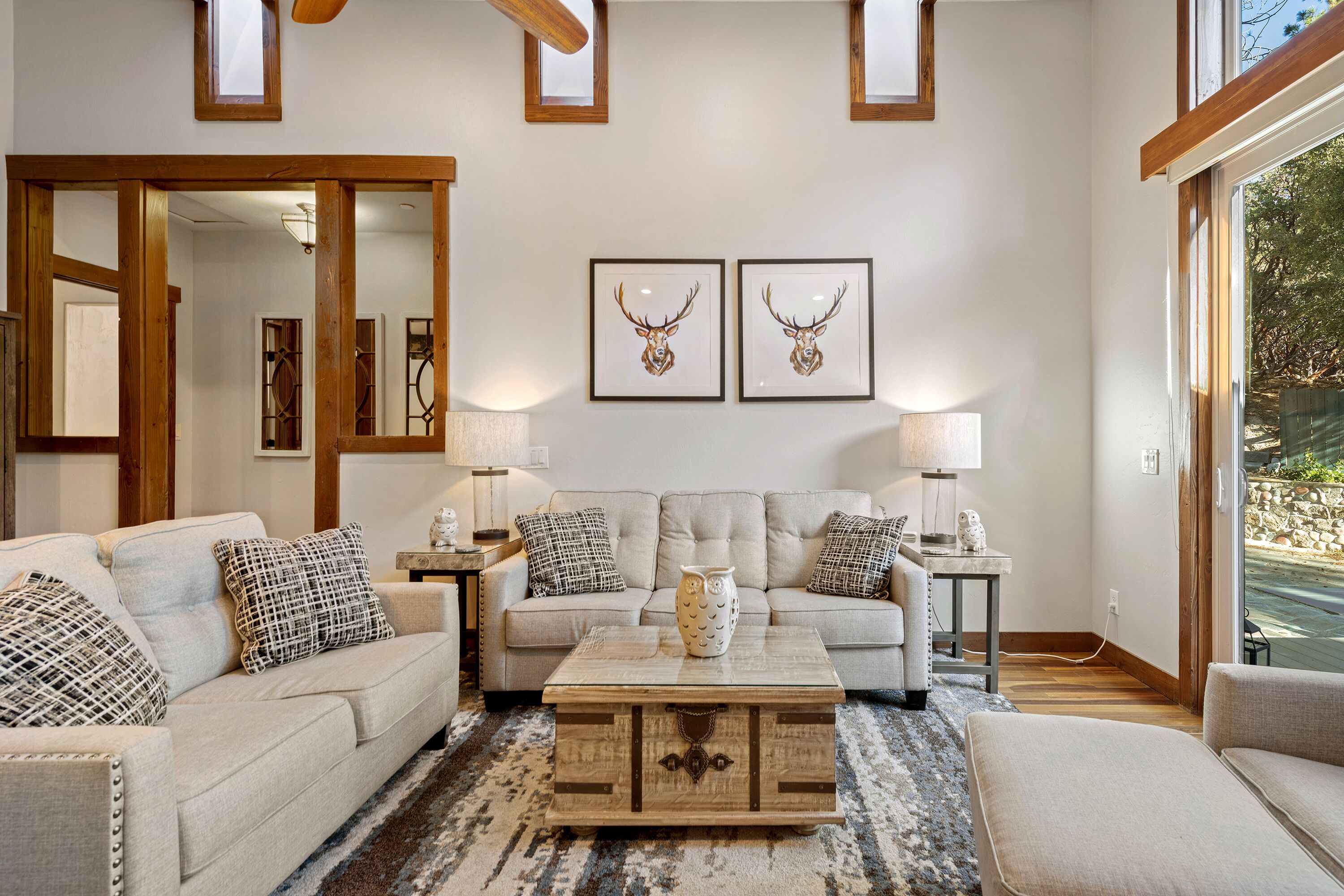 A living room with a sofa set, a coffee table, and two wall-mounted lamps.