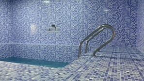 A swimming pool with blue mosaic tiles and a metal handrail. - Super OYO 150 Reef Al Khaleej Resort (Musannah)