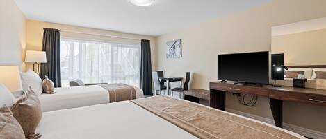 A hotel room with two beds, a desk, a television, and a window with curtains.