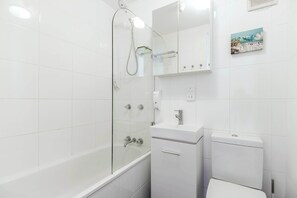 A modern bathroom with a glass-enclosed shower, a white sink, and a toilet. - Stunning Manly Beach views - 906 Manly National (Manly)