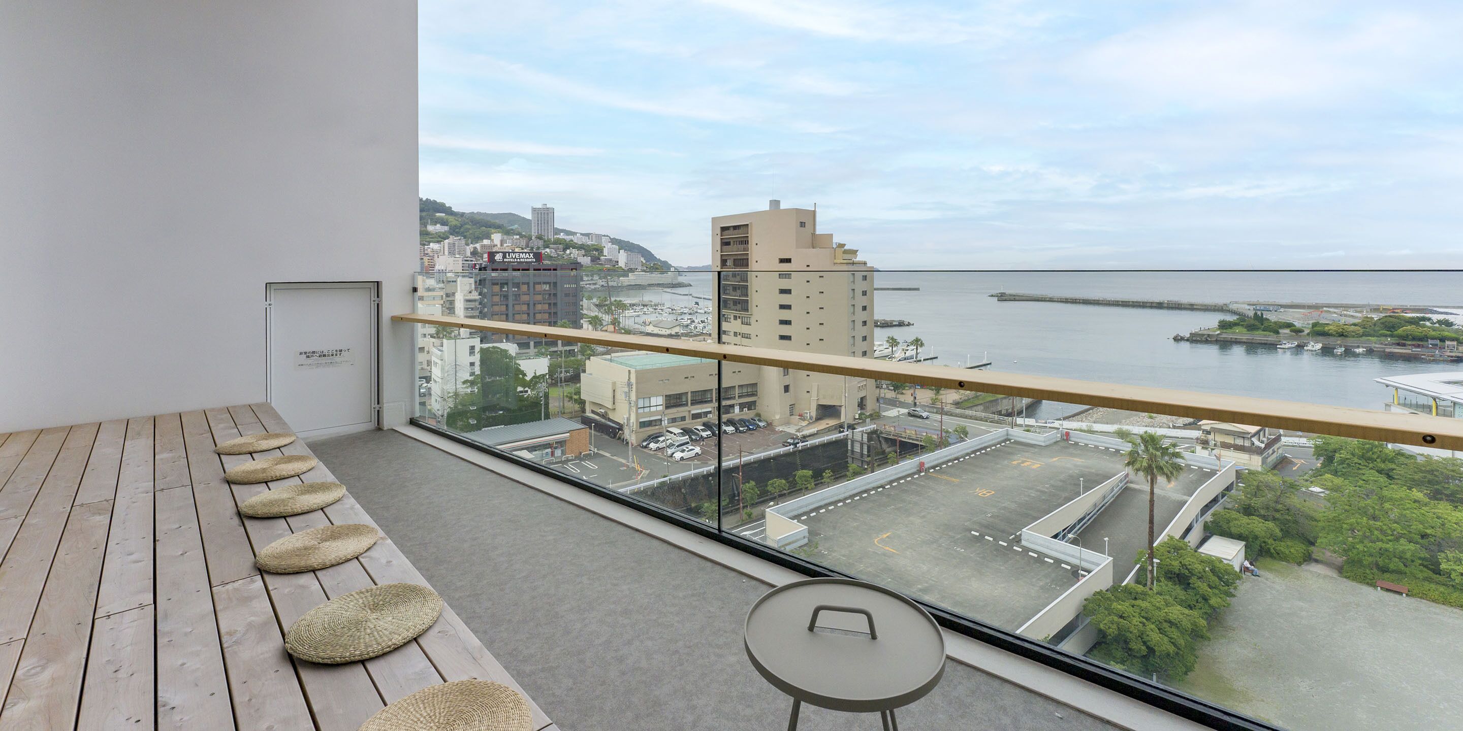 A balcony with a view of a marina and buildings.
