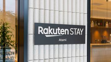 A sign for Rakuten Stay Atami.