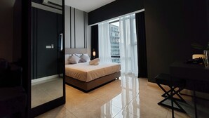 A modern bedroom with a bed, a desk, and a large window. - The Axon Bukit Bintang by SMOVF BNB (Kuala Lumpur)