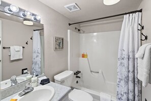 A bathroom with a sink, mirror, and shower. - Snowmass Mountain D1 (Snowmass Village)