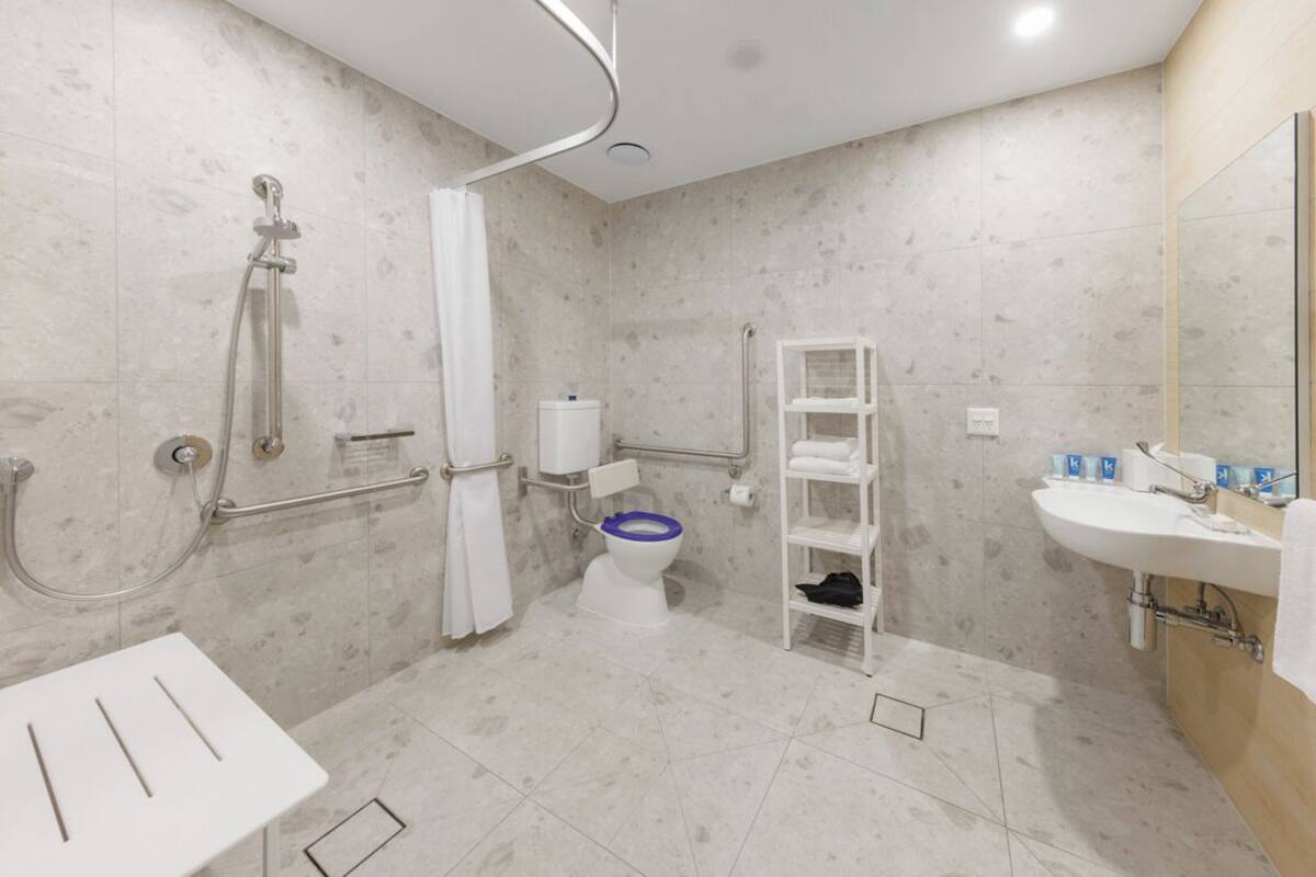 Mini Studio Accessible Suite | Bathroom | Shower, designer toiletries, hair dryer, towels