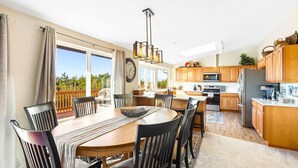A modern kitchen with wooden cabinets, a built-in oven, and a stainless steel refrigerator.