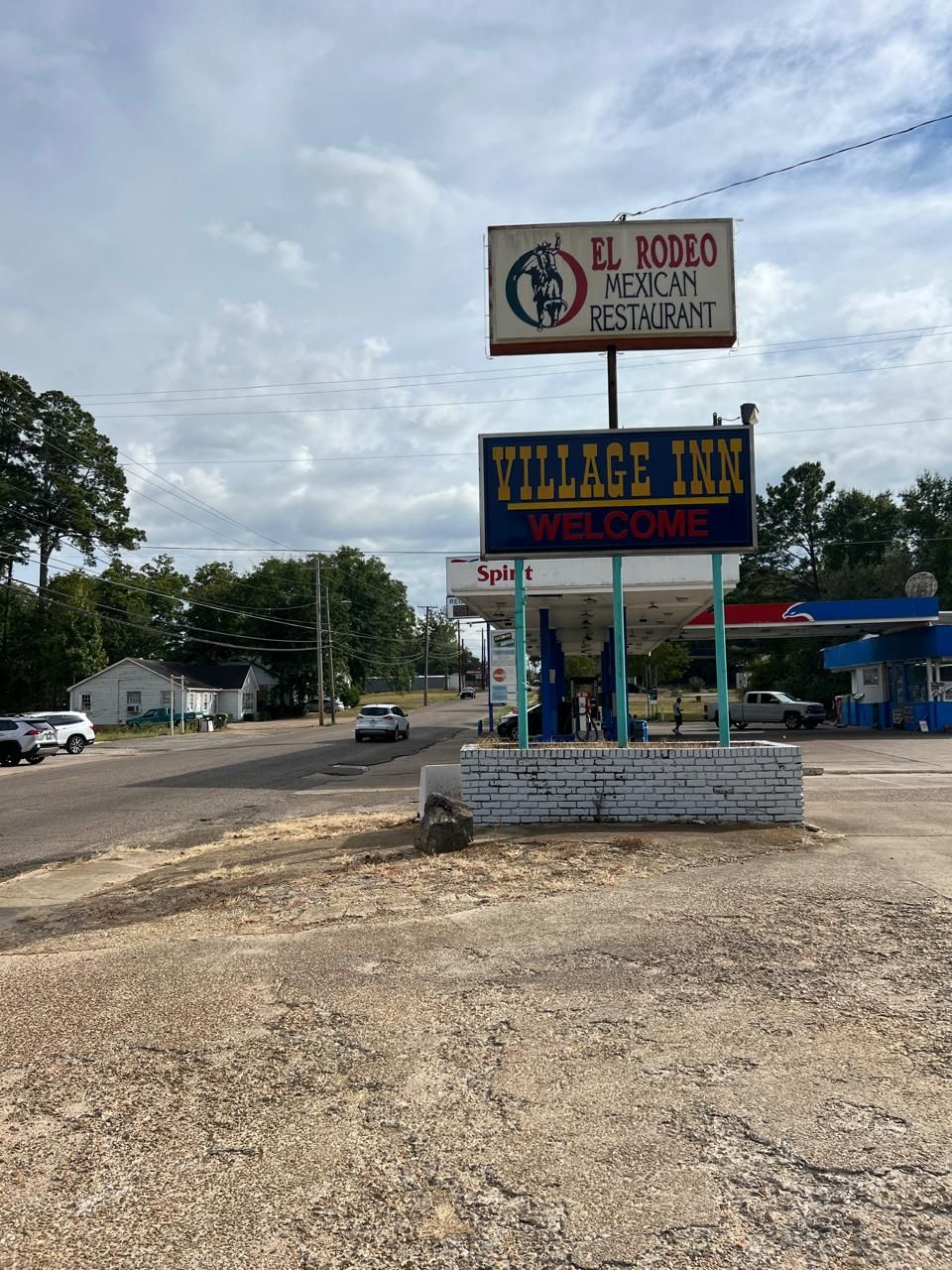 A sign for El Rodeo Mexican Restaurant and Village Inn Welcome.