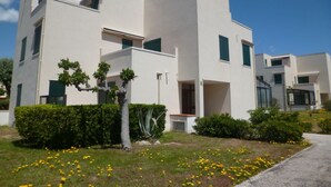 A modern multi-story building with a flat roof, large windows, and a symmetrical facade. - Beautiful apartment for 3 guests with WIFI, TV and terrace (Le Barcarès)