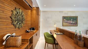 Relax in a stylish room with a wooden bench, woven basket, and a comfortable chair.