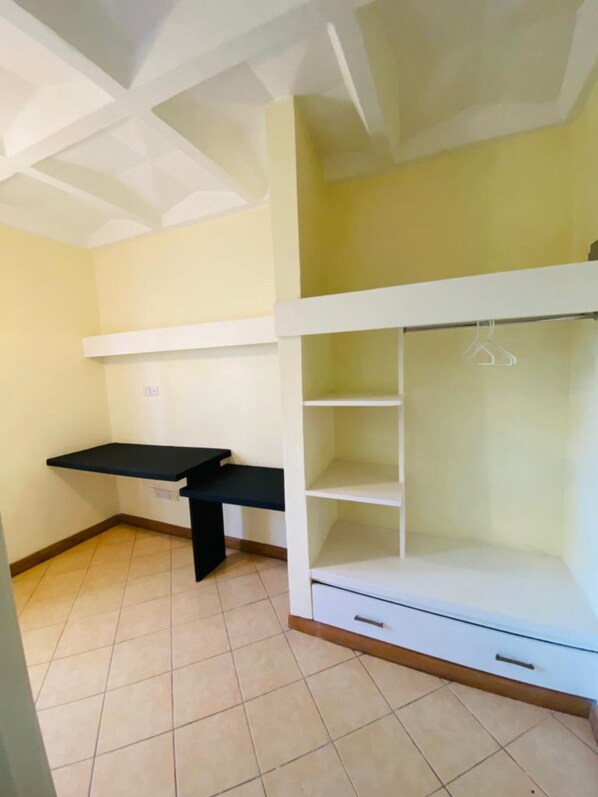 A room with a bunk bed, a desk, and a wardrobe. - Residence By Mahanaim (Juja)