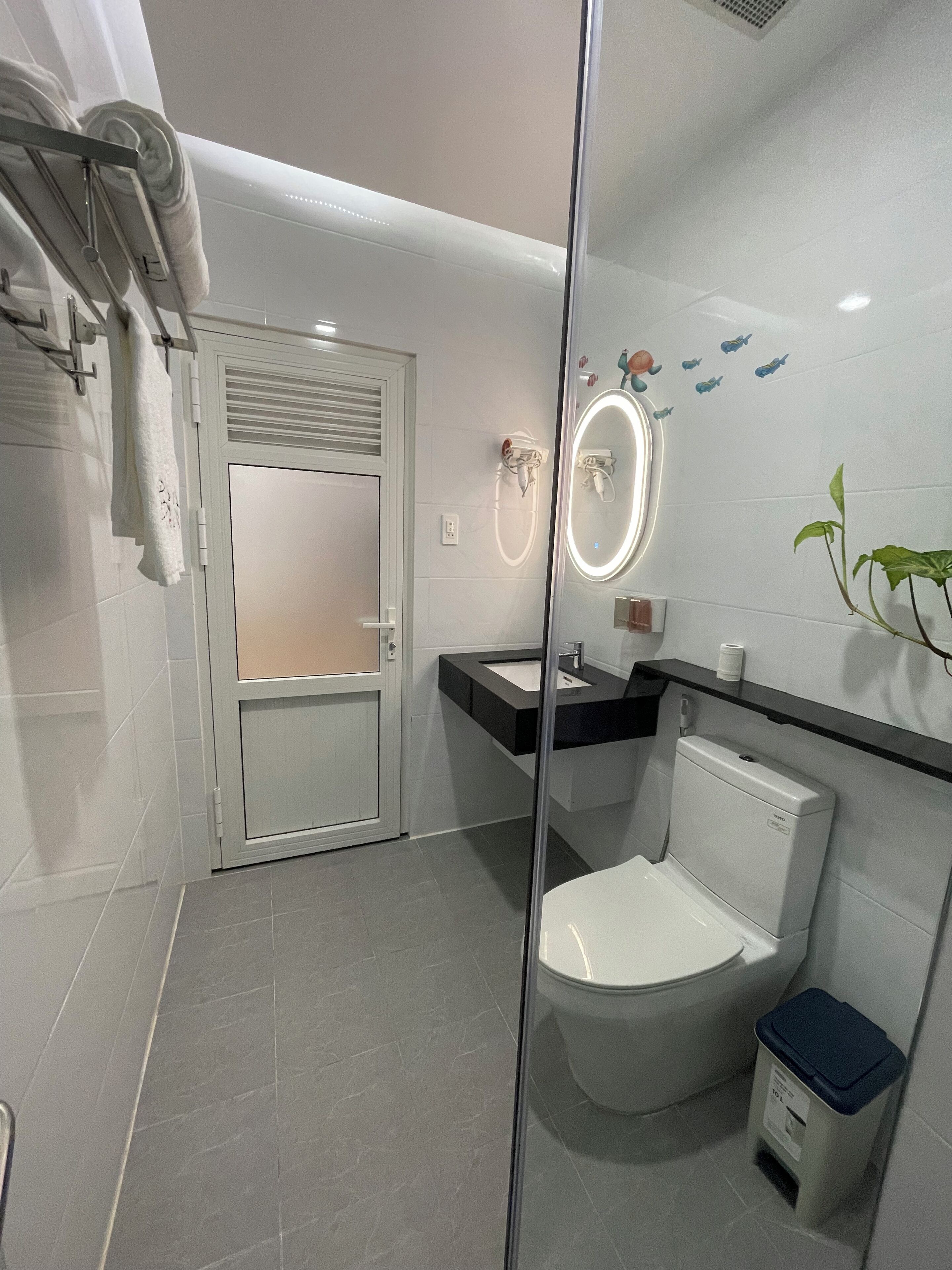 A modern bathroom with a toilet, sink, and shower area.