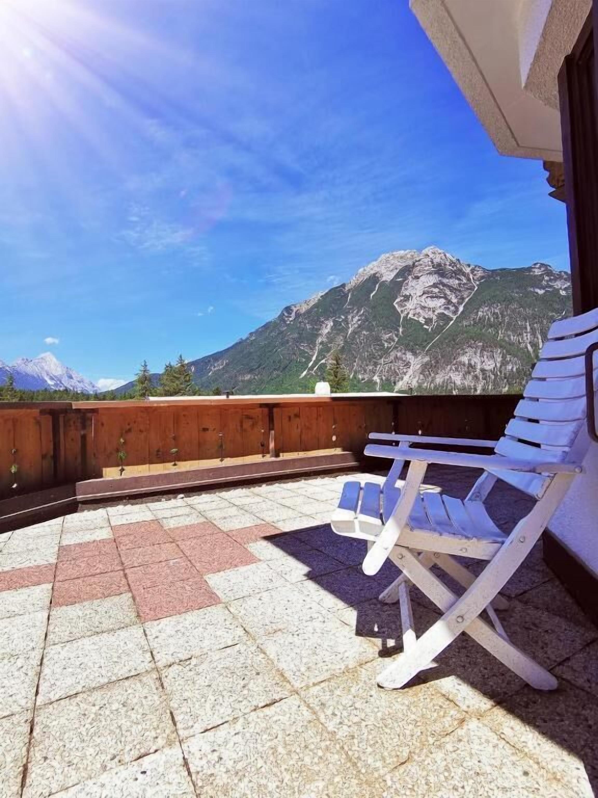A balcony with a view of a mountain range.