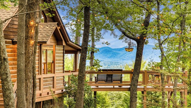 A wooden cabin with a deck, surrounded by trees and a mountain view. - Blue Ridge Tradition -View, location, dog friendly (Blue Ridge)