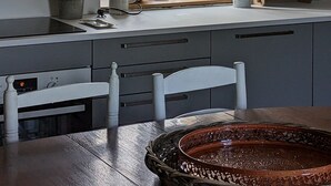 A kitchen with a window, a clock, and a rustic wooden cabinet. - Romantic french cottage 6 persons with pool, 15 min from Rocamadour/Dordogne (Reilhaguet)