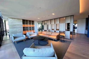 A spacious living area with a sofa, chairs, and a coffee table.