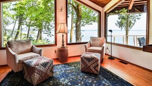 A room with large windows, two armchairs, a lamp, and a patterned rug. - Family Friendly Water View Retreat w/ Sauna (Port Ludlow)
