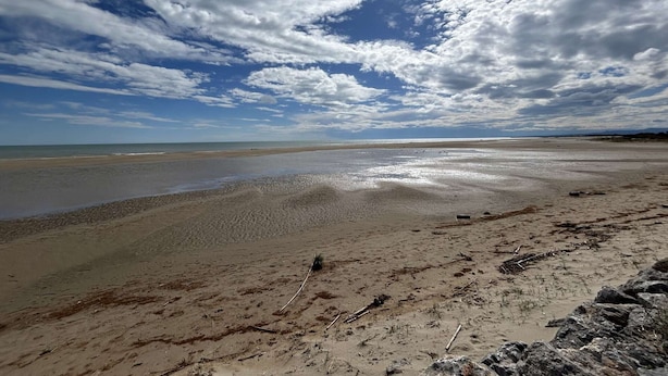 A beach with a wide sandy area and a rocky foreground. - Seaside Apartment: 2 Rooms, Sleeps 5, Modern, 50m from Beach, A/C, Parking Included (Narbonne)