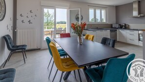 A modern kitchen with a dining area.