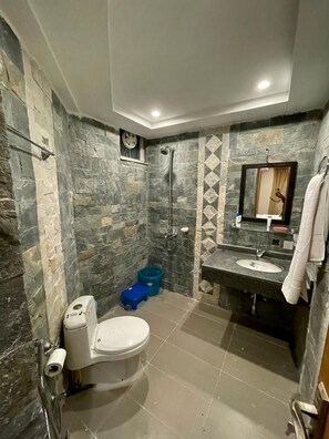 A bathroom with a toilet, sink, and shower. - GOHO ROOMS Murree (Murree)
