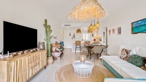 A living room with a TV, a dining area, and a sofa. - Villa Gadea 7-2 Apartment with Sea Views, Wi-Fi, and Air Conditioning (Altea)