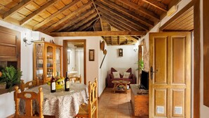A dining area with wooden furniture, a table with a tablecloth, and a wooden ceiling. - Holiday Home 'Casa Rural Ciso' with Sea View, Private Garden and Wi-Fi (tijarafe)